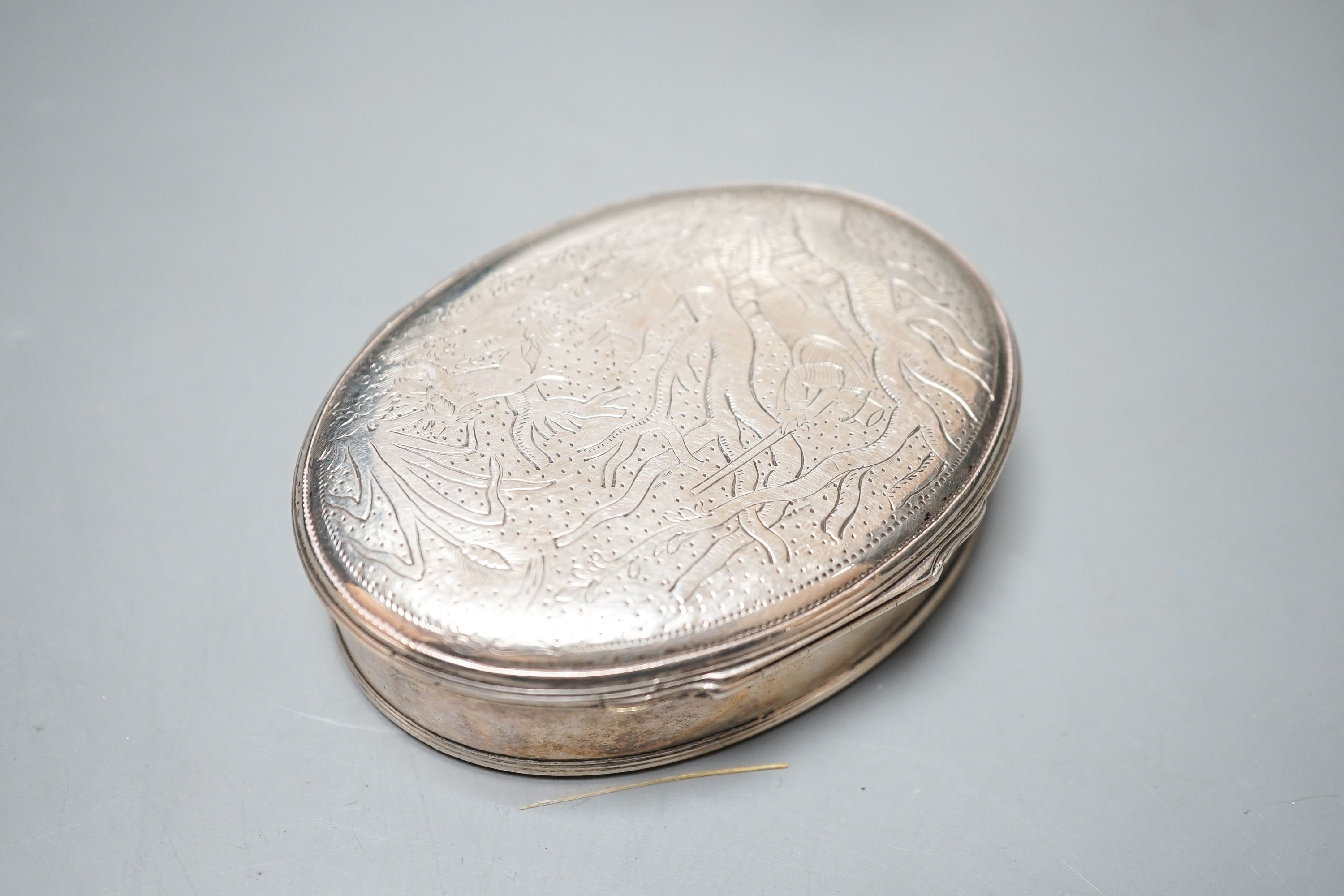 A continental oval white metal snuff box, engraved with hunting scenes, 72mm, a silver oval snuff box with Sheffield, import marks, a silver heart shaped box and a silver cigarette box.